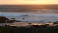 Rocky ocean coast, dramatic sea waves, Monterey beach, California, birds flying. Royalty Free Stock Photo