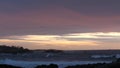 Rocky ocean coast sea waves, Monterey beach California, birds flying, sunset sky Royalty Free Stock Photo