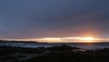 Rocky ocean coast, sea waves, Monterey beach, California, dramatic sunset sky. Royalty Free Stock Photo