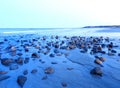 Rocky ocean sandy beach shore at blue sunset in Gloucester Massachusetts Royalty Free Stock Photo