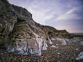 Rocky outcrop on beach at foot of cliff