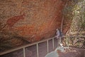 A woman viewing the ancient Australian Aborigines`s rock painting at at Nourlangie in Kakadu National Park, Australia,