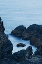 Rocky Pacific Ocean coast at sunset with blue tones Royalty Free Stock Photo