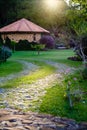 rocky pathway leading to wooden structure, forest in background. Royalty Free Stock Photo