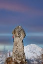 Rocky peak with a couple of climbers in ropes