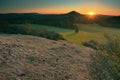 Rocky peak with daybreak. Full moon night ends and sun appeared Royalty Free Stock Photo