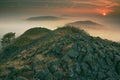 Rocky peak with daybreak. Full moon night ends and sun appeared Royalty Free Stock Photo