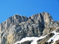 Rocky peak Mutteristock 2295 m in the in the Schwyz Prealps mountain range, and over the WÃÂ¤gitalersee reservoir lake