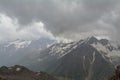 Rocky peaks with snow in the clouds, North Caucasus Elbrus region. Royalty Free Stock Photo