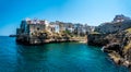 A rocky peninsula marks the entrance to the coastal inlet at Polignano a Mare, Puglia, Italy