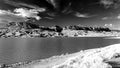 Rocky ridge across the lake at the Buffalo Bill Reservoir in black and white IR