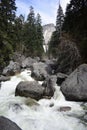 Rocky river with big boulders surrounded by green trees