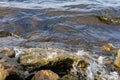 Rocky riverbank. Waves rise against rocks Royalty Free Stock Photo