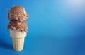 Rocky Road Ice Cream Cone on a Blue Background Royalty Free Stock Photo