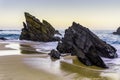Rocky and sandy beach at sunrise, Portugal Royalty Free Stock Photo