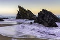 Rocky and sandy beach at sunrise, Portugal Royalty Free Stock Photo