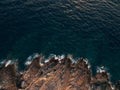 Rocky sea coast, waves hitting the rocks, aerial top view.