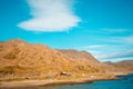 Rocky sea shore with blue cloudy sky. Mageroya island, Norway Royalty Free Stock Photo