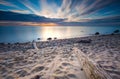 Rocky sea shore with driftwood at sunrise. Beautiful seascape Royalty Free Stock Photo