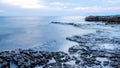 Rocky seashore and calm blue ocean Royalty Free Stock Photo