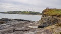 Rocky seashore in Ireland in summer. Seaside landscape. rocky shore under white cloudy sky