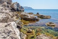 The rocky seashore with the purest transparent blue water