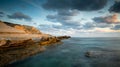 Rocky seashore seascape with dramatic and beautiful sunset at sea caves coastal area in Paphos, Cyprus