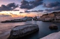 Rocky seashore seascape with dramatic and beautiful sunset at sea caves coastal area in Paphos, Cyprus