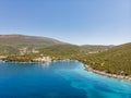 Rocky seaside near Veslo camping in Montenegro. Azure blue water, white waves hitting the rocks, sunny summer day. Royalty Free Stock Photo
