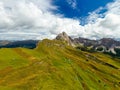 Rocky Seceda ridgeline overgrown with grass on sunny day