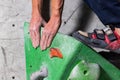 Rocky shoe on a tiny, scanty snare stands with the tip of the sock in close-up on the climbing wall in the room Royalty Free Stock Photo