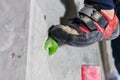 Rocky shoe on a tiny, scanty snare stands with the tip of the sock in close-up on the climbing wall in the room