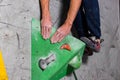 Rocky shoe on a tiny, scanty snare stands with the tip of the sock in close-up on the climbing wall in the room Royalty Free Stock Photo