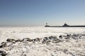 Rocky shore along frozen Lake Superior with pier and lighthouses Royalty Free Stock Photo