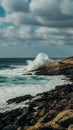 Rocky shore braves crashing waves, a testament to natures power