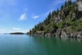 Rocky shore of Flathead Lake, Montana on calm summer morning. Royalty Free Stock Photo