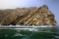 Rocky shore of lake Baikal in the fog in winter Royalty Free Stock Photo