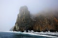 Rocky shore of lake Baikal in the fog in winter Royalty Free Stock Photo