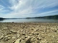 Rocky shore of Lake Solinskie visible mountains Bieszczady clear water