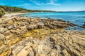 Rocky shore in Le Bombarde beach Royalty Free Stock Photo