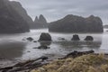 A rocky shoreline with a foggy, misty atmosphere Royalty Free Stock Photo