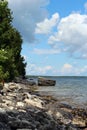 The rocky shoreline of Lake Michigan, with a rocky outcropping, in the summer in Cave Point County Park Royalty Free Stock Photo