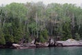 The rocky shoreline of Lake Superior lined with Birch and evergreen trees in Bayfield, Wisconsin Royalty Free Stock Photo