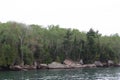 The rocky shoreline of Lake Superior lined with a dense forest in Bayfield, Wisconsin, USA Royalty Free Stock Photo