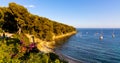 Rocky shoreline landscape of Saint-Jean-Cap-Ferrat resort town with sightseeing path on Cap Ferrat cape in France