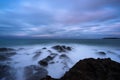 Rocky shoreline blue ocean sunset surf seascape long exposure