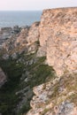 Rocky shores of the Dzhangul landslide coastline in the rays of the setting sun