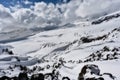 Rocky slope of Mount Elbrus covered with snow