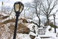 Rocky Stairs Going Up and Street Lights Covered in Snow at Central Park during the Winter in New York City Royalty Free Stock Photo