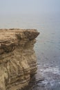 Rocky steep cliff of Cyprus coast to deep blue Mediterranean sea